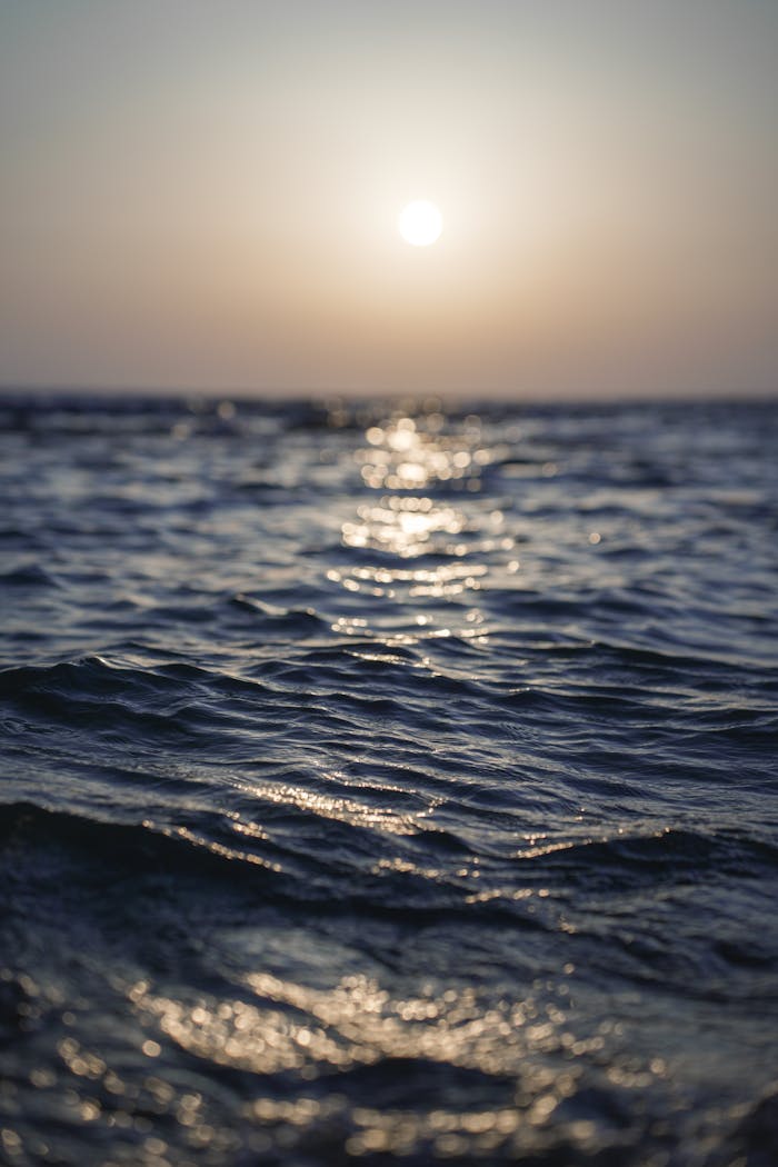 A sunset over the ocean with waves